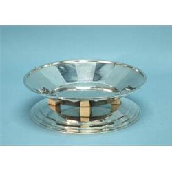 ART DECO - An important French silver centrepiece. Circular faceted bowl raised on four ivory blo…