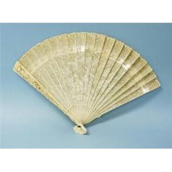 An antique French carved ivory fan. Satin ribbon holding together 21 panels depicting an elaborat…