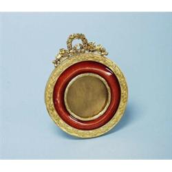 A fine antique French gilt bronze and enamel miniature picture frame. Of circular form. Front wit…
