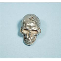An antique silver miniature pill box sculpted in form of a skull. With pendant attachment. Marked…