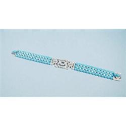An unusual 18 kt. white gold, diamond and turquoise bracelet. Three rows of 4 mm beads interspace…