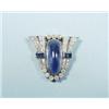 Image 1 : ART DECO - A platinum and diamond shield shaped brooch. Set with a central oval cut cabochon sapp…