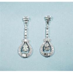 A pair of Art Deco design 18 kt. white gold and diamond earpendants. Each set with a very fine pe…
