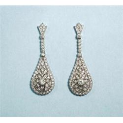 A pair of 18 kt. white gold diamond set earpendants. Each pear shaped drop of very fine filligree…