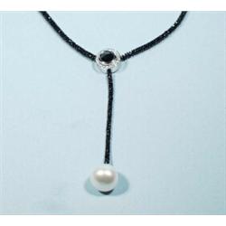 An exceptional black diamond and pearl necklace. A central pave set diamond circular decoration w…