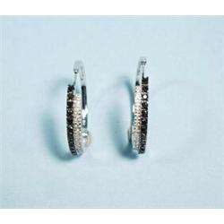 A pair of attractive 18 kt. white gold and diamond hoop earrings. Set with alternating rows of bl…