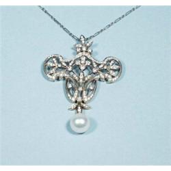 A Belle Epoque design 18 kt. white gold and diamond pendant with matching gold chain. The shield …