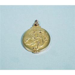 ART NOUVEAU - An 18 kt. yellow gold locket. Relief decorated with diamond set daisies, back with …