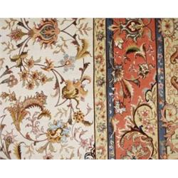 A semi-antique Persian silk and wool Tabriz carpet. Signed. Appx. size: 6'8" x 10'2".…