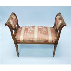 An antique French Louis XVI style carved oak window bench. Upholstered in striped and flowered sa…