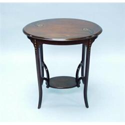 ARTS & CRAFTS - A fine turn of the 20th century English satinwood inlaid two-tier table. The oval…