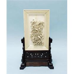 An antique Chinese ivory table screen on pierce work carved blackwood base. The rectangular ivory…