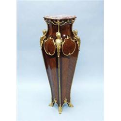 An antique French Louis XV style kingwood and tulipwood pedestal with rouge marble top. The serpe…