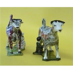 TWO CREAMWARE MILKING GROUP COW CREAMERS AND COVERS, English. 1800-1820. Each standing four squ...