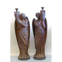 GOOD PAIR OF CAST IRON FIGURES OF ANGELS, Each wearing a long robe, holding an amphora, on a ci...