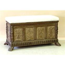 CONTINENTAL CARVED OAK CASSONE, 19th Century. The rectangular padded hinged top opening to a ce...