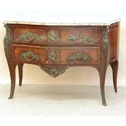 LOUIS XV STYLE GILT BRONZE MOUNTED MAHOGANY COMMODE, French. Early 19th Century. The serpentine...