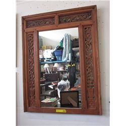 Vintage wall mirror with a carved wood frame