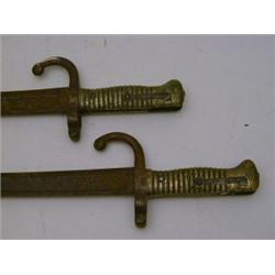 A PAIR OF BAYONETS, late 19th Century, brass grips, length 70cm (2)  40-60...
