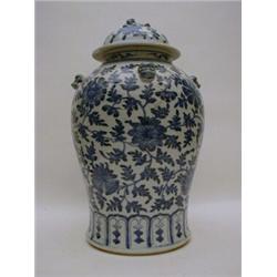 AN ORIENTAL BLUE AND WHITE JAR AND COVER, 19th Century, of waisted shape, decorated with scrollin...