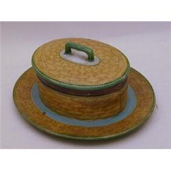 A MINTONS MAJOLICA BUTTER DISH, and cover, 1876, turquoise interior, basket work moulded exterior...