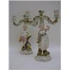 Image 1 : A PAIR OF TINTED BISQUE CANDLESTICKS, late 19th Century, for two lights, boy and girl figures, ma...