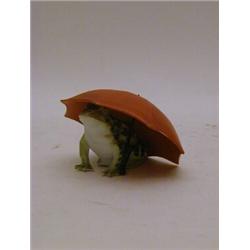 A TINTED BISQUE ANIMAL FIGURE, frog beneath an umbrella, height 6cm  30-40...