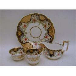 A SERIES OF DAVENPORT TEA WARES, mid 19th Century, burnished gilding reserving blue scrollwork an...