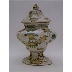 A TIN GLAZED EARTHENWARE URN AND COVER, of bombe form, polychrome floral decoration, dated '1742'...
