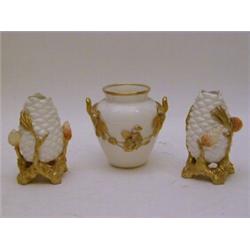 A ROYAL WORCESTER TWIN HANDLED VASE, applied gilded swags, height 9cm and a pair of small vases m...