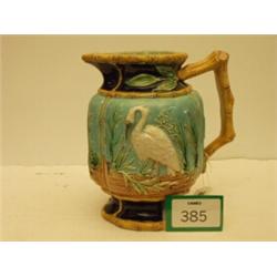 Superb Majolica jug embossed with cranes, having bamboo style handle and borders…