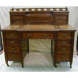 A Victorian carved mahogany breakfront pedestal kneehole writing desk by Maple & Co, the upper se...