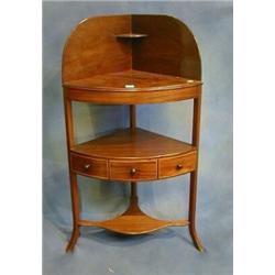 A Georgian mahogany corner wash stand with undertier fitted a drawer, raised on splayed supports...