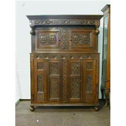 An early 18th Century carved oak court cupboard, the upper section fitted a double cupboard enclo...