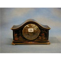 A 1920's striking mantel clock with silvered dial, Roman numerals contained in an arched chinoise...