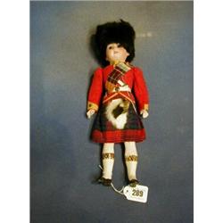 A 19th Century Armand Marseille porcelain headed costume doll of a Scotts soldier in Highland uni...