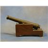 Image 1 : A 19th Century bronze model firing canon 12" raised on a wooden trunion £100-150...