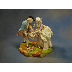 A 19th Century Continental biscuit porcelain figure group of Lady and Gentleman cradling a child...