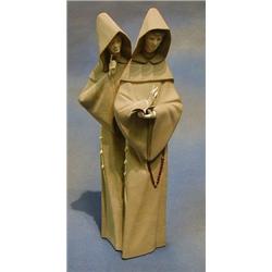 A Lladro figure of 2 standing monks, the base marked Lladro with matt finish 14" £75-100...