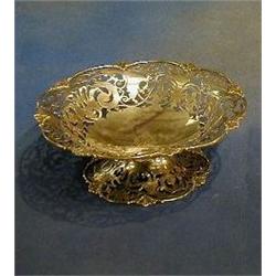 A circular pierced silver bowl by Mappin & Webb, raised on a circular spreading base London 1912,...