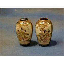 A pair of 19th Century Japanese Satsuma pottery vases with panelled decoration decorated court fi...