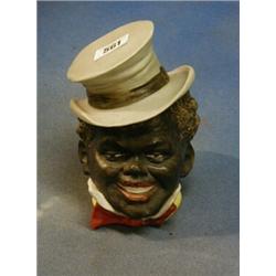 A 19th Century trinket box in the form of a top hatted Negro 4" £30-50...
