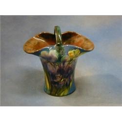 A Torquay pottery basket shaped flower vase with floral decoration, the base impressed signature...