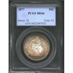 1877 50C MS66 PCGS. A breathtaking Gem specimen with frosty, untoned centers and peripheral accents.