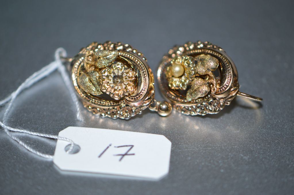 A pair of antique stamped .800 gold earrings. Retail replacement value