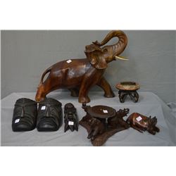 Selection of carved collectibles including elephant, antelope, three masks, pot stand, ash tray, etc