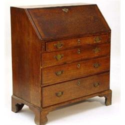 George III oak bureau, the mahogany cross banded fall enclosing an arrangement of pigeon holes an…