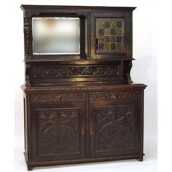 Carved oak sideboard, the super structure with bevelled mirror and a leaded glazed door, the lowe…