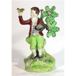 Early 19th century Walton hand painted Staffordshire figure of a young boy with birds and nest an…