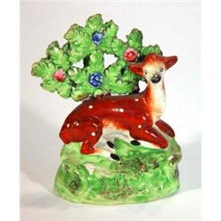 Early 19th century hand painted Staffordshire figure of a deer with floral brocage, 11cm high…